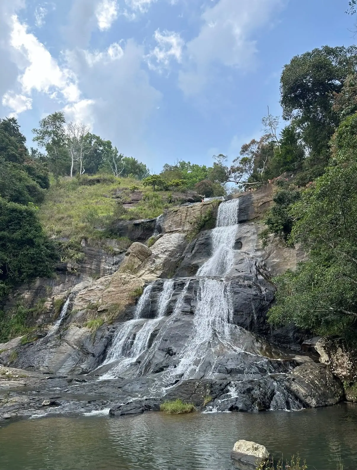 A waterfall cascading down rocks in the Sri Lankan hill country