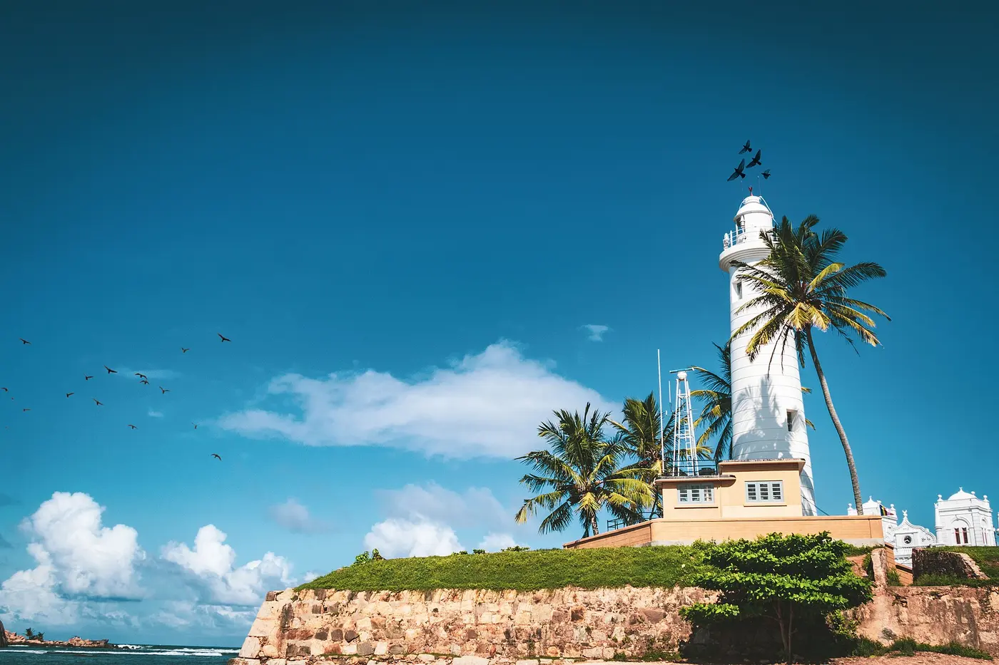 White lighthouse and palm trees at Galle Fort